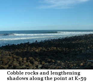 Cobble rocks and lengthening shadows along the point at K-59.